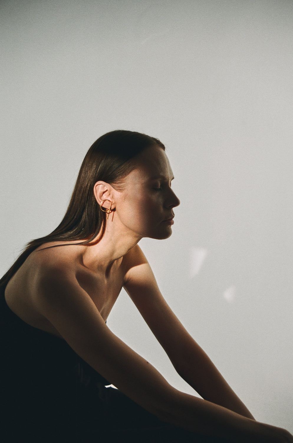 ⁠Architectural jewellery gold earring